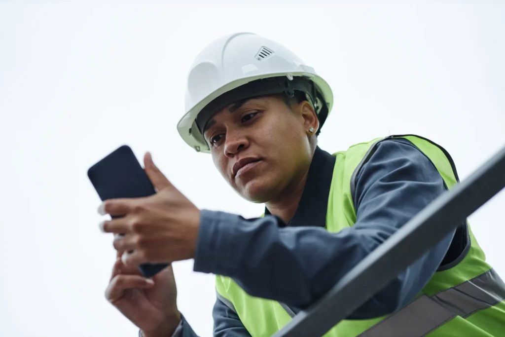 Construction worker using mobile phone at work